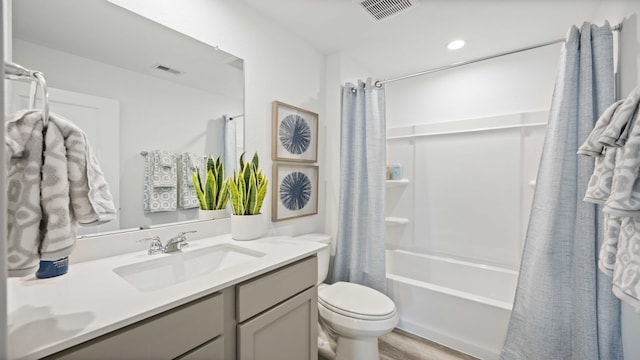 full bath featuring vanity, shower / tub combo, toilet, and visible vents