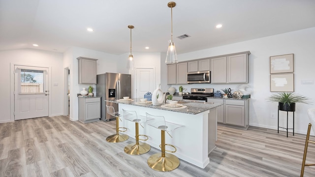 kitchen with appliances with stainless steel finishes, gray cabinets, and recessed lighting