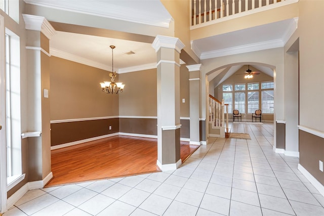 4103 Oak Blossom Ct, Houston, TX 77059 - entrance foyer with crown molding, arched walkways, ceiling fan with notable chandelier, and ornate columns