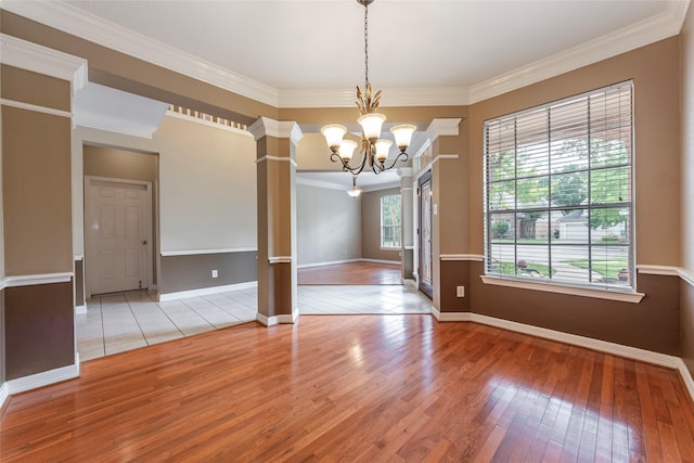 4103 Oak Blossom Ct, Houston, TX 77059 - empty room featuring crown molding, a chandelier, hardwood / wood-style floors, baseboards, and ornate columns