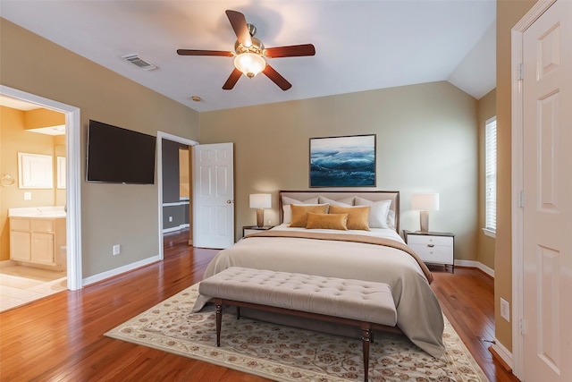 4103 Oak Blossom Ct, Houston, TX 77059 - bedroom with visible vents, connected bathroom, baseboards, and wood finished floors