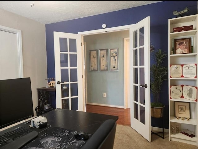 11303 Olympia Dr, Houston, TX 77077 - office area featuring carpet floors, a textured ceiling, baseboards, and french doors