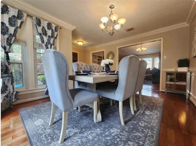 11303 Olympia Dr, Houston, TX 77077 - dining room with crown molding, a notable chandelier, wood finished floors, and visible vents