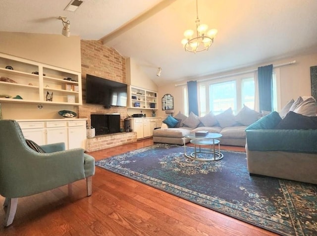 11303 Olympia Dr, Houston, TX 77077 - living area with visible vents, wood finished floors, a fireplace, vaulted ceiling with beams, and a chandelier