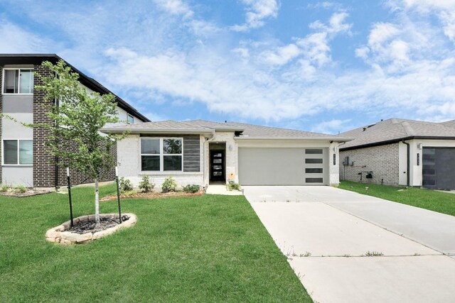 view of front of property with an attached garage, concrete driveway, brick siding, and a front yard