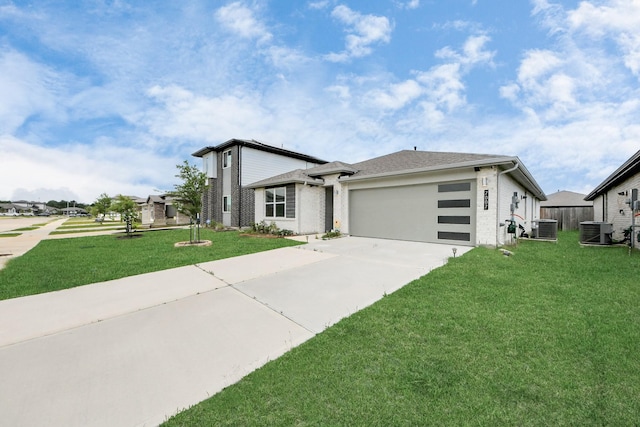 view of front of house featuring central air condition unit, an attached garage, driveway, and a front yard