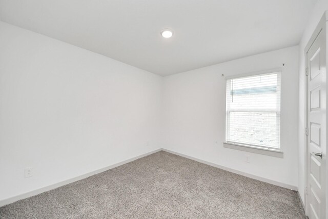 carpeted empty room with baseboards and recessed lighting
