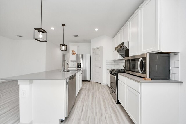 kitchen with visible vents, a sink, light wood finished floors, and stainless steel appliances