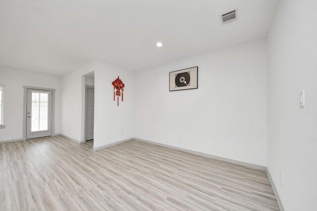 spare room with recessed lighting, baseboards, visible vents, and light wood-style floors