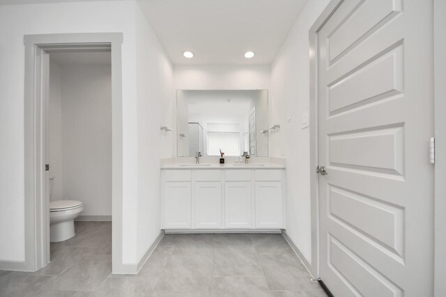 bathroom featuring double vanity, a sink, and tile patterned flooring