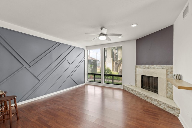 unfurnished living room with ceiling fan, visible vents, a fireplace, wood finished floors, and recessed lighting