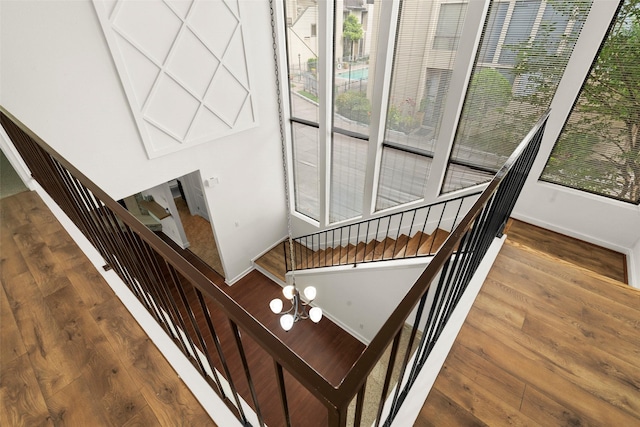 stairs with baseboards and wood finished floors