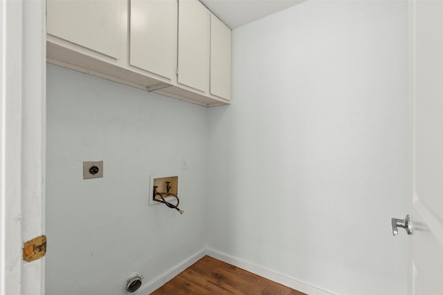 laundry area featuring hookup for an electric dryer, dark wood-style flooring, cabinet space, baseboards, and hookup for a washing machine