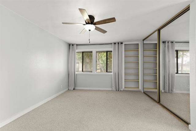 unfurnished bedroom featuring baseboards, carpet, and a closet