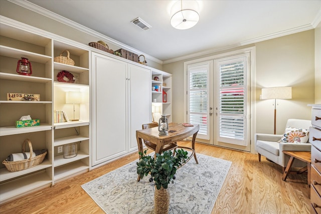 office area featuring visible vents, light wood-style floors, and crown molding