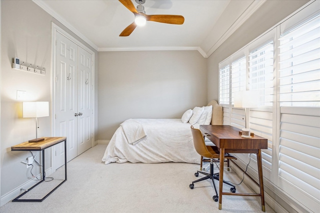 bedroom featuring ornamental molding, carpet, and a closet