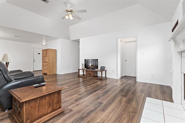 living room featuring a ceiling fan, high vaulted ceiling, wood finished floors, and a fireplace