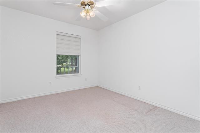 empty room with baseboards, a ceiling fan, and carpet flooring