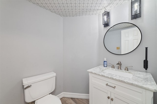13414 Autumn Valley Dr, Cypress, TX 77429 - half bath featuring baseboards, toilet, vanity, and wood finished floors