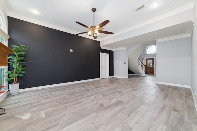 13414 Autumn Valley Dr, Cypress, TX 77429 - unfurnished living room featuring a ceiling fan, stairs, light wood finished floors, baseboards, and ornamental molding