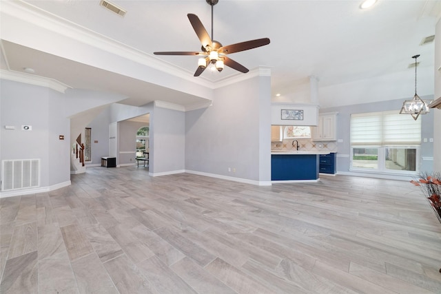 13414 Autumn Valley Dr, Cypress, TX 77429 - unfurnished living room with a ceiling fan, ornamental molding, stairs, a sink, and baseboards