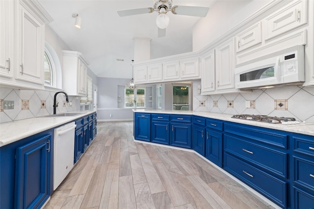 13414 Autumn Valley Dr, Cypress, TX 77429 - kitchen with blue cabinets, white appliances, a sink, white cabinets, and ceiling fan