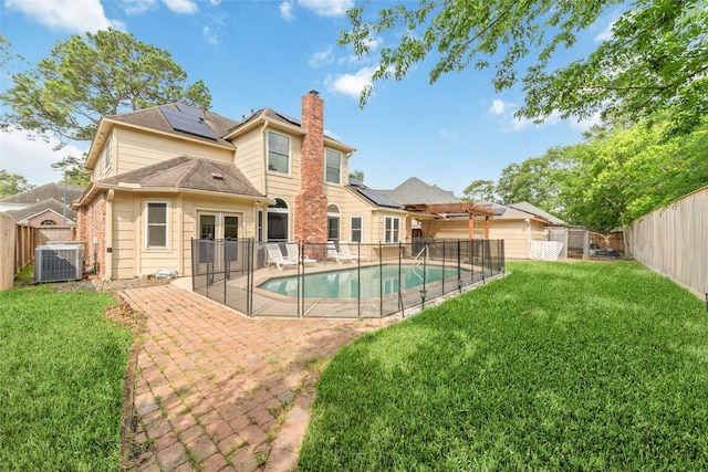 13414 Autumn Valley Dr, Cypress, TX 77429 - back of house featuring central AC, roof mounted solar panels, a patio area, a chimney, and french doors