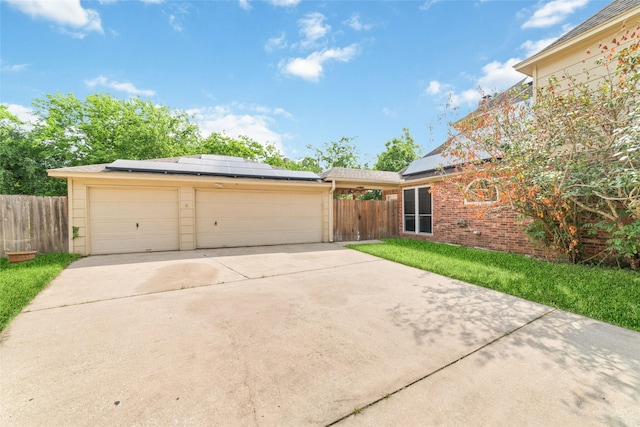 13414 Autumn Valley Dr, Cypress, TX 77429 - single story home featuring roof mounted solar panels, fence, brick siding, driveway, and a garage