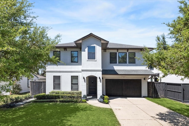 view of front of property featuring fence, stucco siding, driveway, and a garage