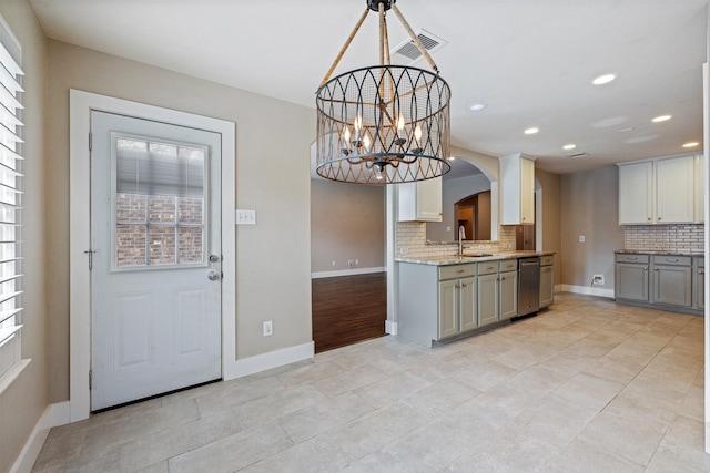 kitchen featuring decorative backsplash, visible vents, stainless steel dishwasher, a sink, and recessed lighting