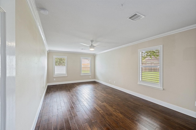 spare room with crown molding, baseboards, visible vents, and a healthy amount of sunlight