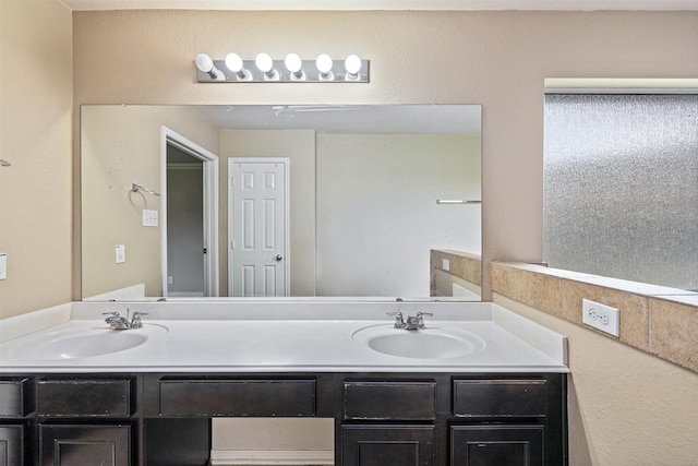 bathroom with a sink and double vanity