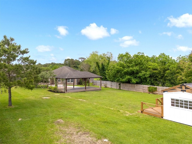 view of yard featuring a gazebo, a fenced backyard, and a detached carport
