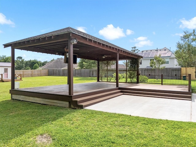 view of patio with a fenced backyard, an outbuilding, and a deck