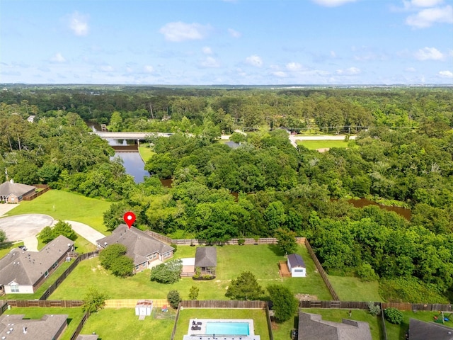 bird's eye view with a wooded view