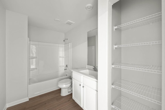full bathroom with toilet, shower / bath combination, wood finished floors, and vanity