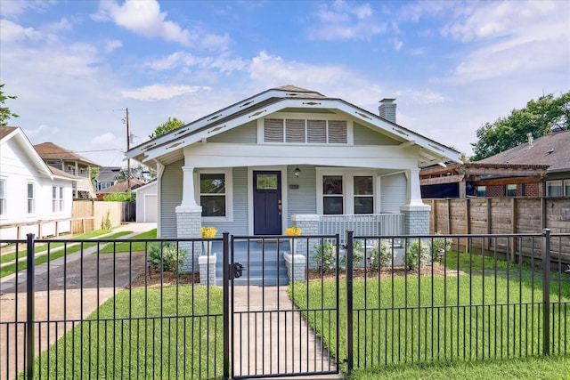bungalow-style home featuring a fenced front yard, a front lawn, a porch, a gate, and a chimney
