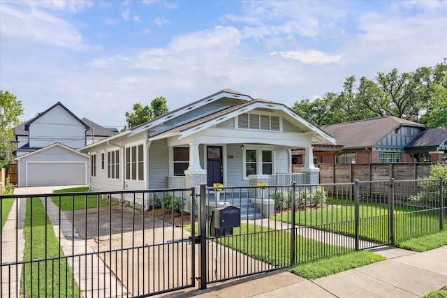 bungalow-style home featuring driveway, a fenced front yard, covered porch, and a front yard