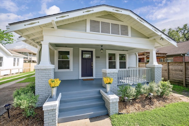 view of front of property with fence and a porch