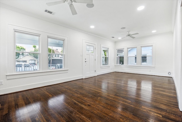 unfurnished living room featuring ceiling fan, ornamental molding, baseboards, visible vents, and dark wood-style floors