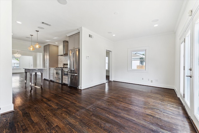 unfurnished living room with visible vents, ornamental molding, and dark wood-style floors