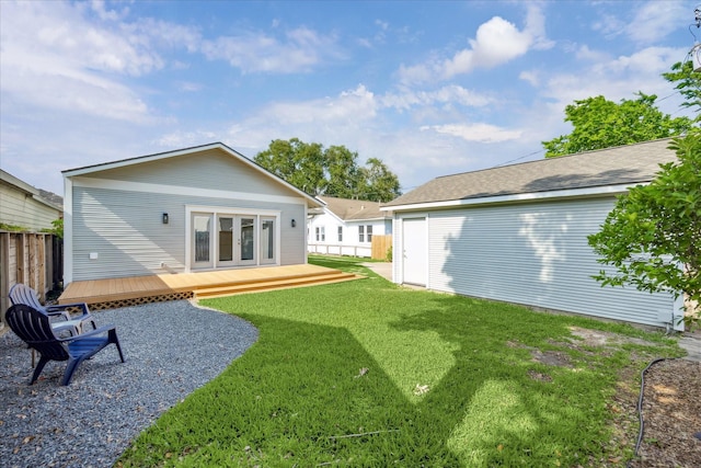 back of house with fence, a yard, a deck, and french doors