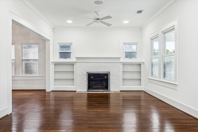 unfurnished living room featuring crown molding, visible vents, built in features, and wood finished floors