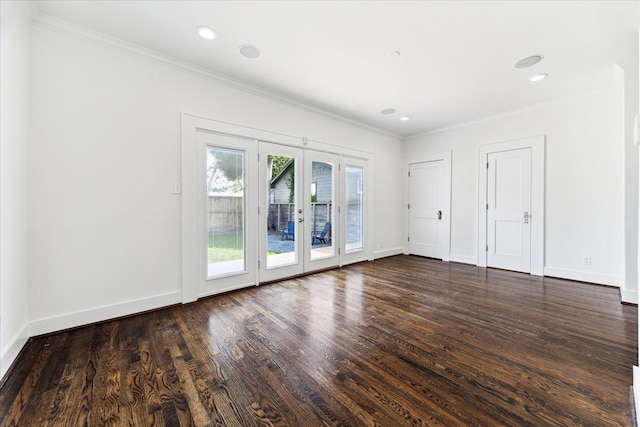 unfurnished room with crown molding, french doors, and dark wood-style floors