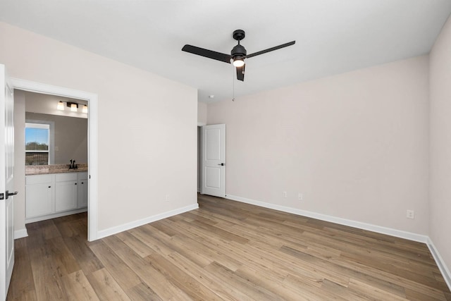 3031 Sunmoon Ln, Katy, TX 77493 - unfurnished bedroom with baseboards, ceiling fan, light wood-style flooring, and connected bathroom