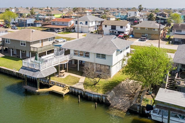 bird's eye view with a water view and a residential view