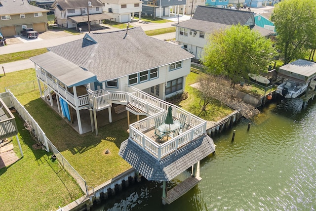 drone / aerial view with a water view and a residential view