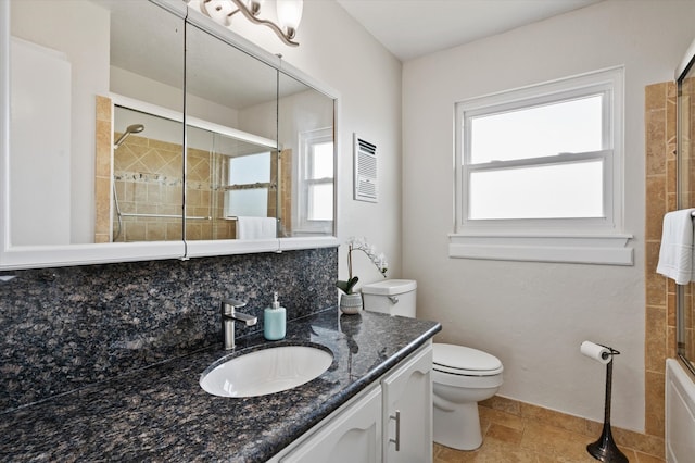 full bath featuring decorative backsplash, toilet, a wealth of natural light, and tiled shower