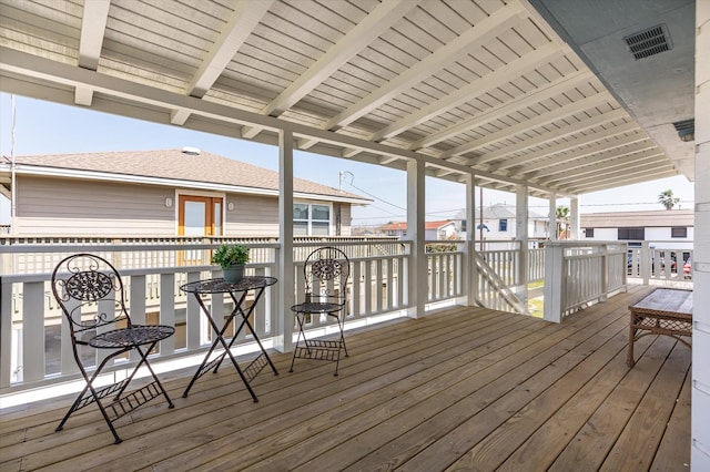 wooden terrace featuring visible vents