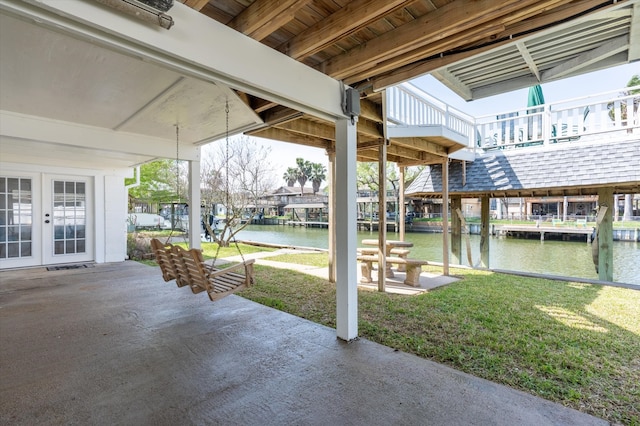 view of patio / terrace featuring a water view and french doors
